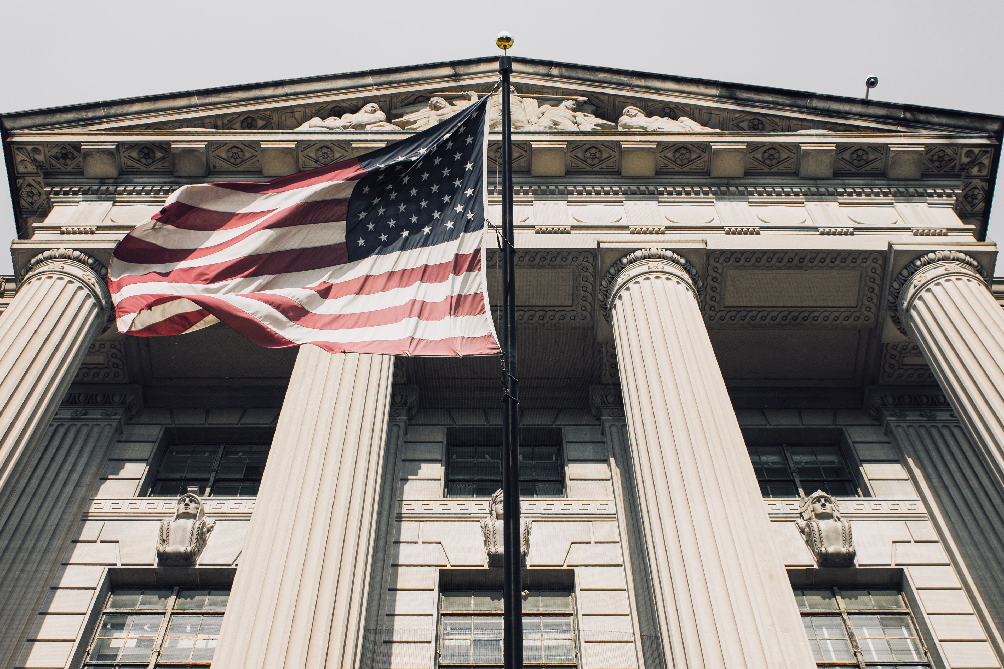 American flag outside a government building representing ShipNYC government sales